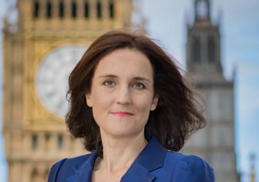 Photo of Theresa Villiers with Parliament in the background